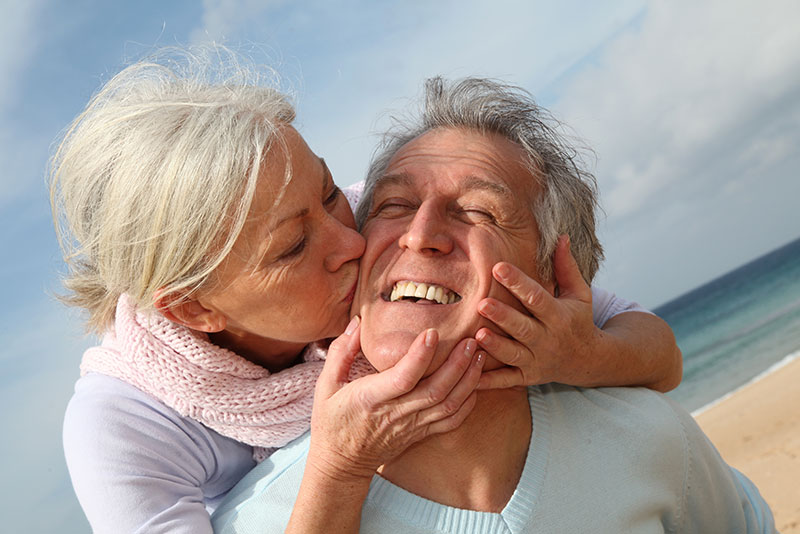 Woman kissing man with hearing loss